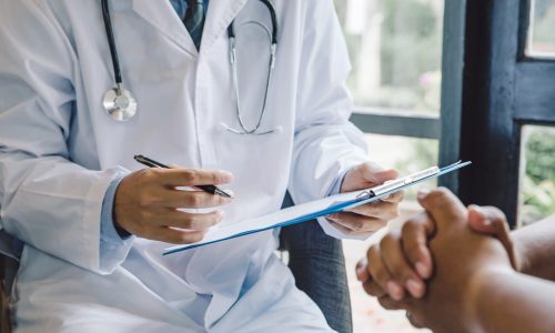 Doctor giving a consultation to a patient and explaining medical informations and diagnosis